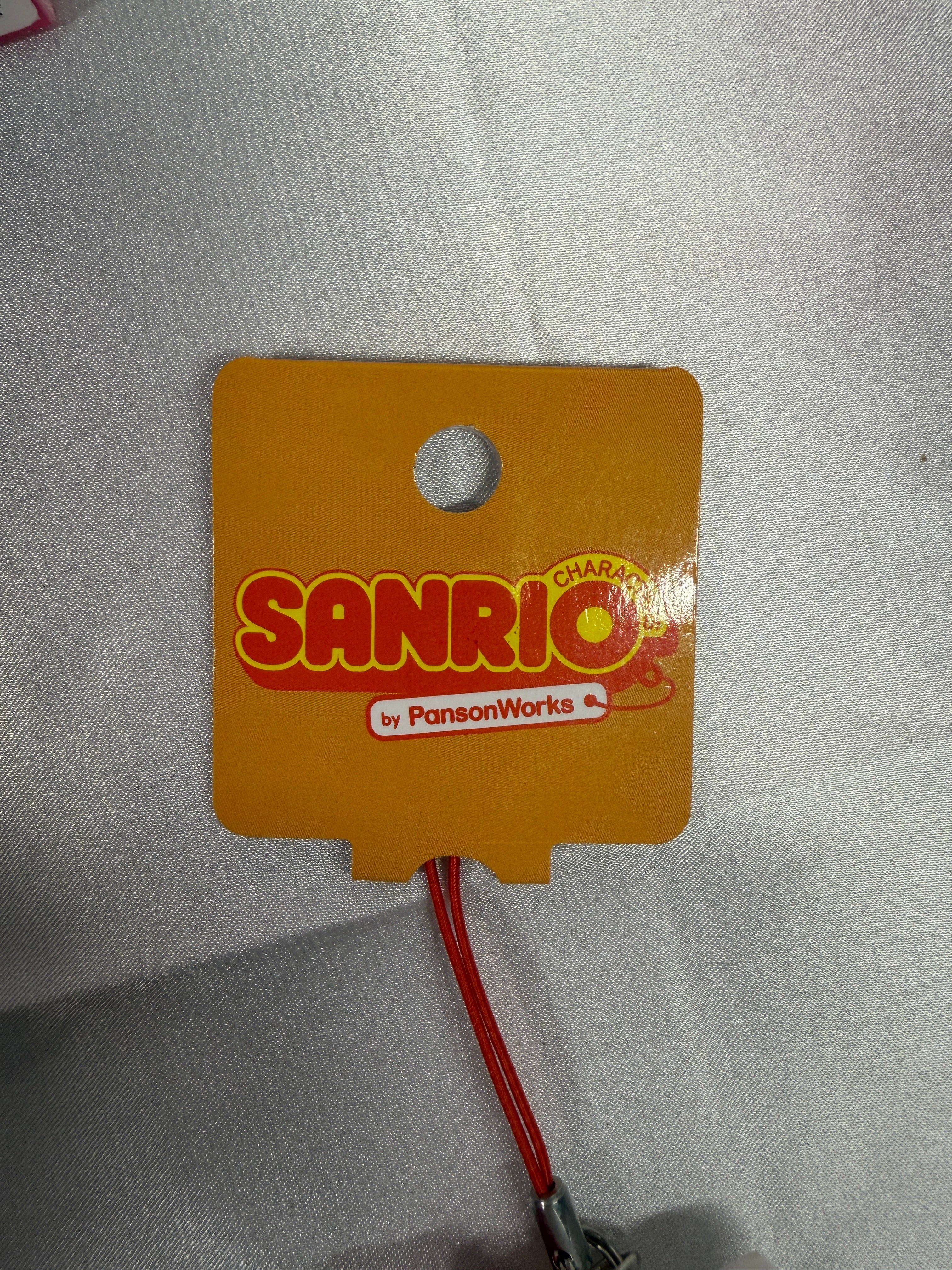 Front of 2011 Sanrio PansonWorks Hello Kitty Squishy Strap paper tag