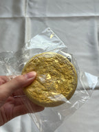 Back of vintage Pompompurin melon bread squishy showing severe surface cracking and deterioration
